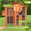 A wooden chicken coop with a wire mesh enclosure, set up on a grassy lawn. Produktbild-Vorschau