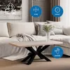A coffee table is shown in a living room setting with a sofa and artwork. Náhľad obrázku produktu