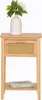 A wooden nightstand with a drawer and a shelf, topped with a white vase containing flowers. Podgląd zdjęcia produktu