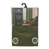 A package containing a green curtain with silver grommets. Náhled obrázku produktu