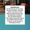 A coffee machine and a jar of coffee beans are visible in the background, with an overlay of German text providing instructions on how to clean the machine. Produktbild-Vorschau