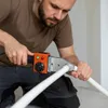 A man is using a pipe welding machine to join two white plastic pipes. Produktbild-Vorschau