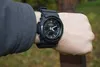 A person wearing a black Casio G-Shock watch on their wrist, outdoors. Náhled obrázku produktu