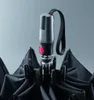 Close-up of the handle and canopy of a black umbrella. Anteprima dell’immagine prodotto