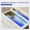 A printer printing a landscape image of a beach with palm trees. Produktbild-Vorschau
