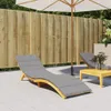 An outdoor patio scene with a wooden fence, a chaise lounge with a gray cushion, and a small wooden table. Náhľad obrázku produktu