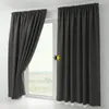 A pair of dark gray blackout curtains hanging on a window. Produktbild-Vorschau