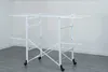 A white metal drying rack with multiple shelves and wheels, set against a plain white and light gray background. Produktbild-Vorschau