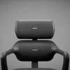 Close-up of the headrest and armrests of a black office chair. Náhled obrázku produktu