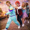 A group of people in costumes dancing at a party. Produktbild-Vorschau