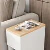 A narrow bedside table with a magazine and a cup of coffee on top, placed next to a sofa. Náhled obrázku produktu
