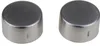 Two silver bottle caps with small vertical lines on the side, placed side-by-side on a white background. Náhled obrázku produktu