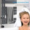 A child is in a bathtub with a towel around her head, next to a heated towel rack with a towel on it. Voir les images du produit