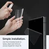 Hands spraying a screen protector with liquid before applying it to a phone. Podgląd zdjęcia produktu