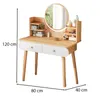 A wooden dressing table with a round mirror and two drawers, displayed on a white background with dimensions indicated. Náhled obrázku produktu