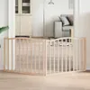 A wooden pet gate is set up in a doorway between two rooms, with furniture visible in the background. Podgląd zdjęcia produktu
