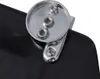 A close-up view of the mounting hardware for a toilet seat, showing screws and a chrome-plated bracket attached to a black surface. Produktbild-Vorschau