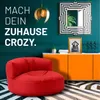 A modern living room scene with a red beanbag chair in the foreground and an orange cabinet in the background. Produktbild-Vorschau