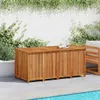 A wooden storage box sits on a patio next to a swimming pool, with greenery and a white wall in the background. Produktbild-Vorschau