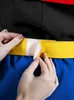 Close-up of hands fastening a yellow belt with velcro. Produktbild-Vorschau