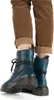 A pair of blue lace-up boots worn with brown corduroy pants and beige socks. Voir les images du produit