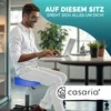 A man working on a laptop while sitting on a blue rolling stool in an office setting. Produktbild-Vorschau