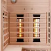 Interior view of a wooden infrared sauna with glowing heating elements. Produktbild-Vorschau