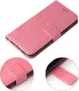 A pink floral flip cover for a phone is shown from a diagonal angle, with close-up insets of the clasp mechanism. Produktbild-Vorschau
