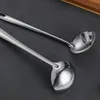 Two stainless steel ladles are placed on a black surface. Produktbild-Vorschau