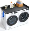 A black wooden top for two washing machines or dryers, with laundry accessories on top. Náhled obrázku produktu