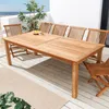 A teak dining set on a wooden deck with a view of the ocean. Produktbild-Vorschau