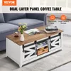 A coffee table with sliding barn doors and storage, placed in a living room setting next to a sofa. Voir les images du produit