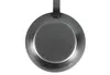 The underside of a frying pan is shown against a white background. Produktbild-Vorschau