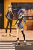 Two anime-style figures are displayed in a street-like setting with a building in the background. Produktbild-Vorschau