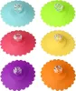 Six colorful silicone cup lids with clear diamond-shaped handles arranged in two rows of three. Produktbild-Vorschau