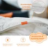 A close-up view of a white duvet with an orange tag that says 'sleepling'. There are also icons and text describing product features. Produktbild-Vorschau