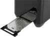 A close-up view of a toaster's crumb tray, which is extended and contains crumbs. Produktbild-Vorschau