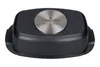 The underside of a black baking dish with a metallic circular logo in the center. Podgląd zdjęcia produktu