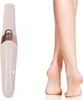 A close-up product shot of an electric callus remover next to a pair of clean, smooth legs and feet. Voir les images du produit