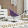 A purple lounge chair is placed on a rug in a room with a dresser and a coffee table. Produktbild-Vorschau