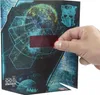 A hand is holding a red transparent sticker over a piece of packaging that features a planet and a Transformers logo. Podgląd zdjęcia produktu