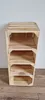 A wooden shoe rack with four shelves against a white wall and on a wooden floor. Produktbild-Vorschau