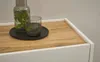 A close-up view of a wooden countertop with a glass and a carafe of water with mint leaves. Produktbild-Vorschau
