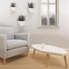 A living room scene with a chair, coffee table, and plants. Produktbild-Vorschau