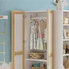 A children's wardrobe with clothes hanging inside and shelves with items. Anteprima dell’immagine prodotto