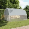 A large, gray chicken coop with a wire mesh enclosure is set up on a green lawn surrounded by trees. Produktbild-Vorschau