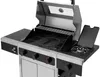 A stainless steel gas grill with the lid open, showing the cooking grates and a side burner. Produktbild-Vorschau