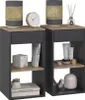 Two identical nightstands are displayed side-by-side against a white background. Each nightstand has a dark gray exterior and a light wood-toned top and shelf. They are decorated with various items, including lamps, a clock, books, and decorative objects. Náhled obrázku produktu