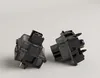 Two black and transparent mechanical keyboard switches are shown against a plain light gray background. Anteprima dell’immagine prodotto