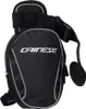A black Dainese leg bag with gray trim and reflective accents, shown against a white background. Voir les images du produit